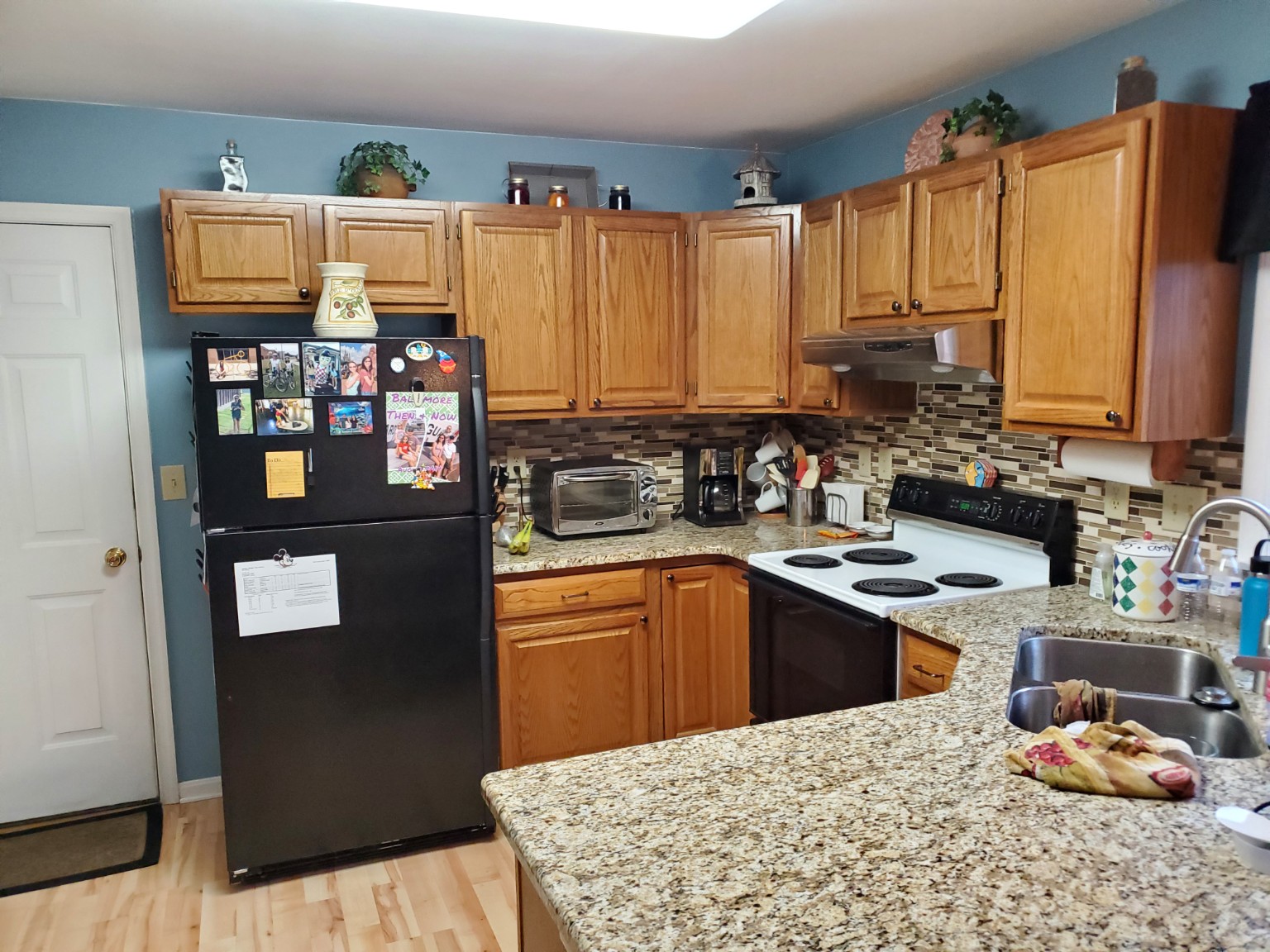 Before: wood kitchen cabinets and peninsula