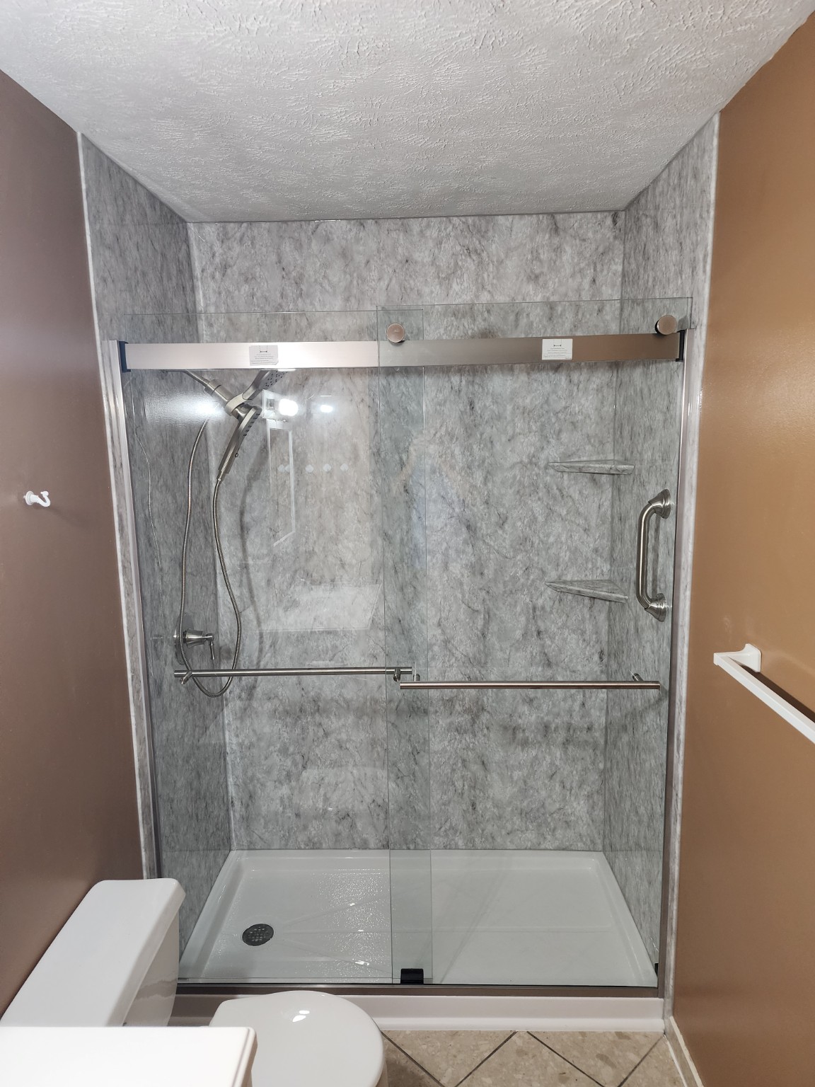After: Tub-to-shower conversion with sliding glass doors