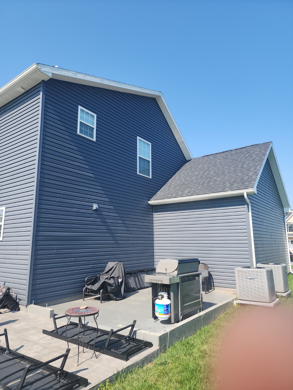 Additional exterior view of the attached shed with siding and gable roof