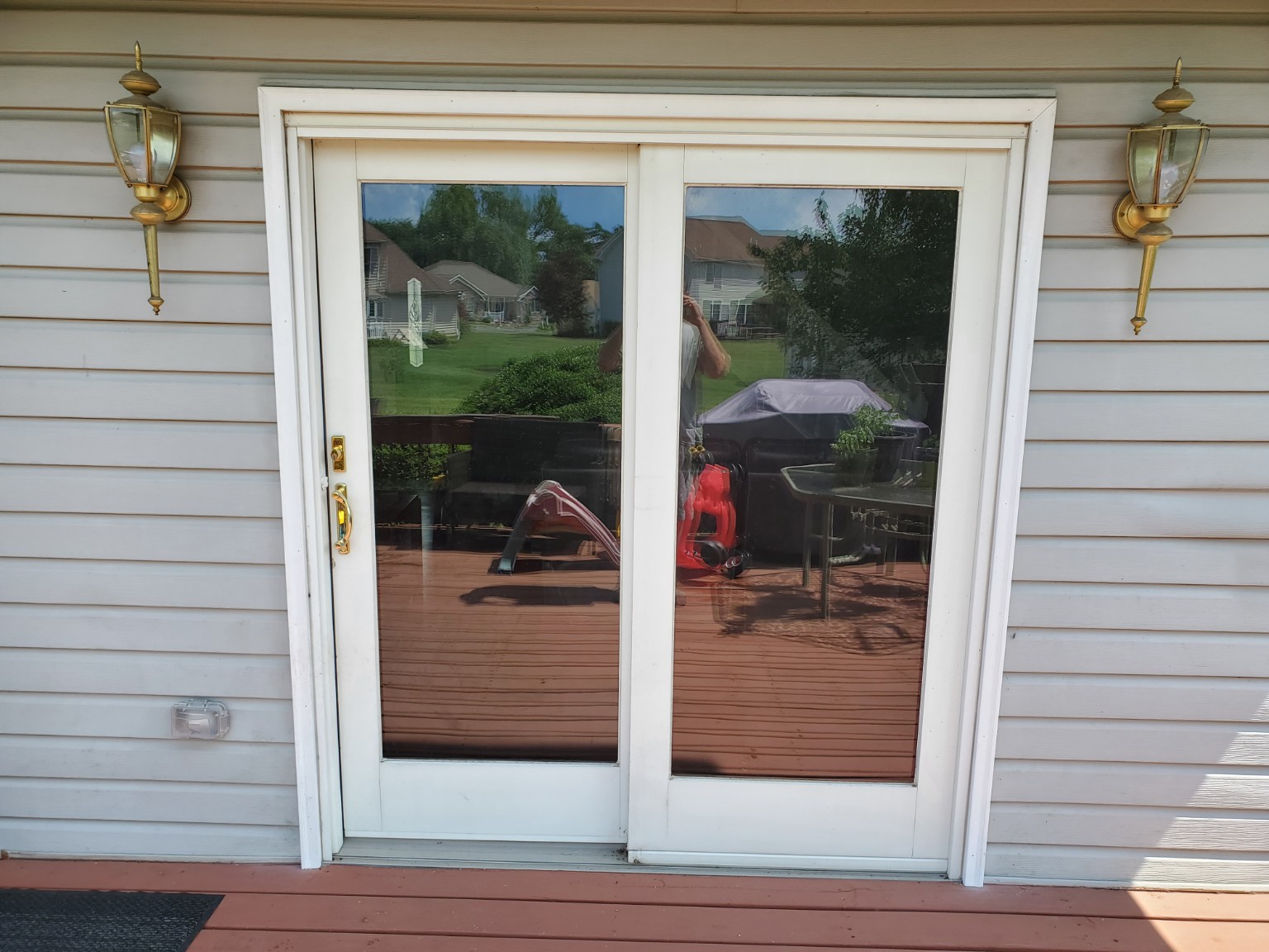 Before: existing patio door with brass handle