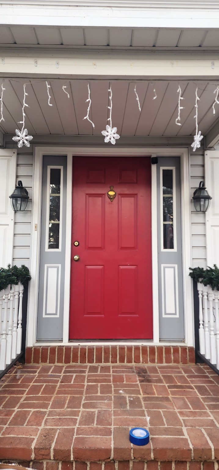 Before: red entry door with narrow sidelights