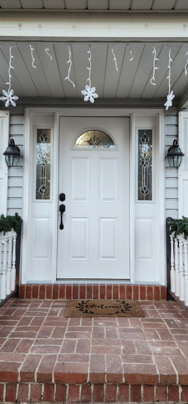 After: white entry door with decorative glass and matching sidelights