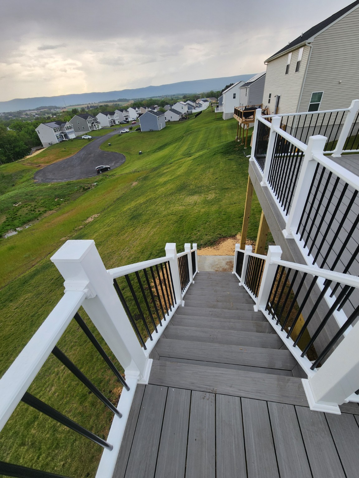 Finished deck stairs leading down to the yard